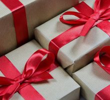 boxes wrapped with gold paper and red ribbon