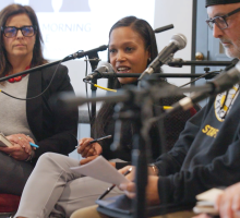 Panelist speaking into a microphone